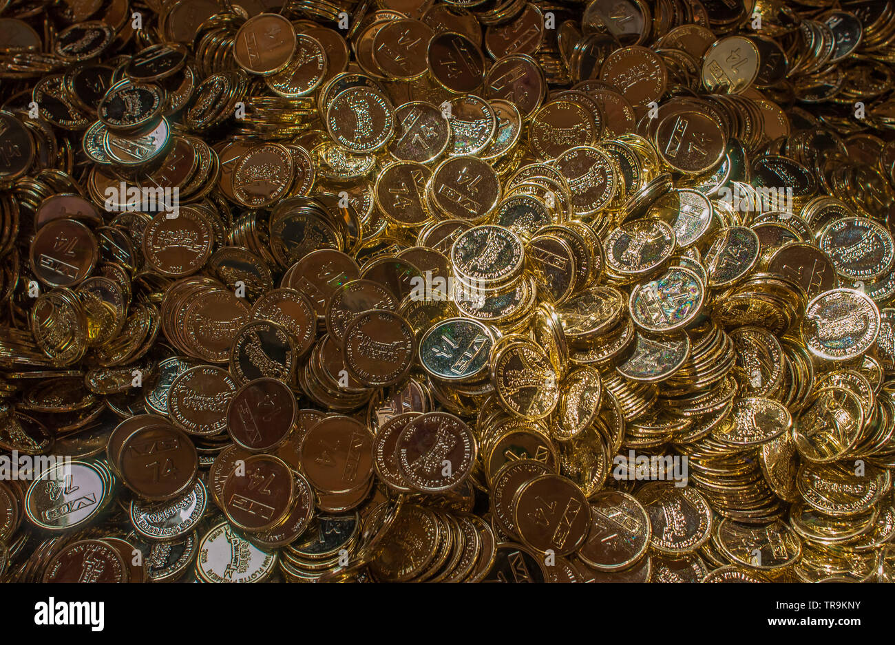 Big pile of plastic gold coins in a treasure chest Stock Photo - Alamy
