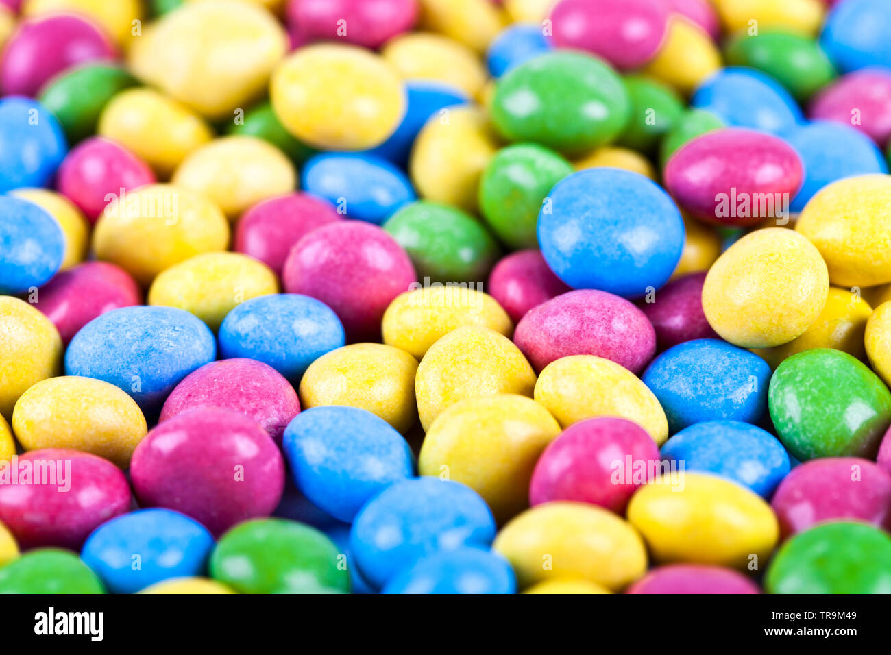 Pile of delicious ainbow colorful chocolate candies background. Macro image. Stock Photo