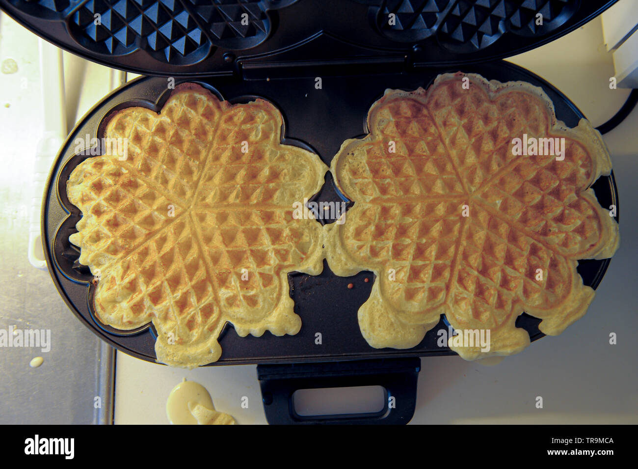 Waffle iron making heart shaped waffles Stock Photo Alamy