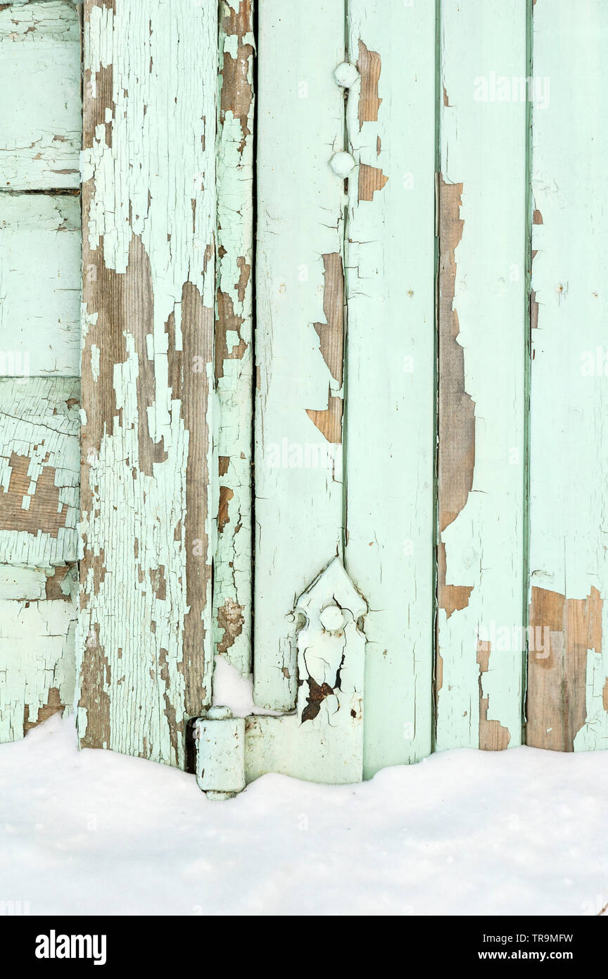 Old painted wall with peeling paint cracked surface Stock Photo