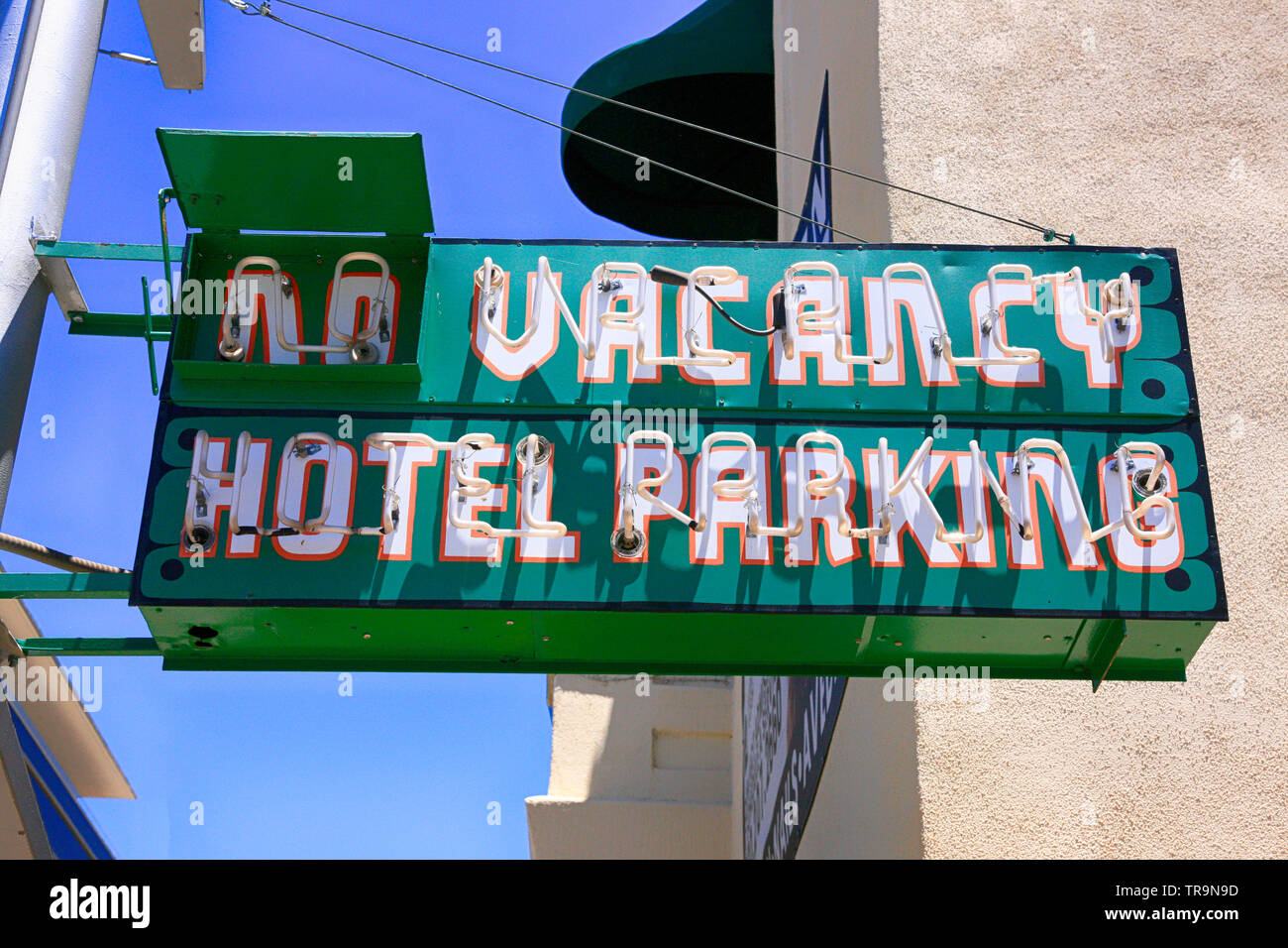 No Vacancy and Hotel Parking overhead neon sign at the Pueblow Hotel and Apartments on 6th Street in Tucson AZ Stock Photo