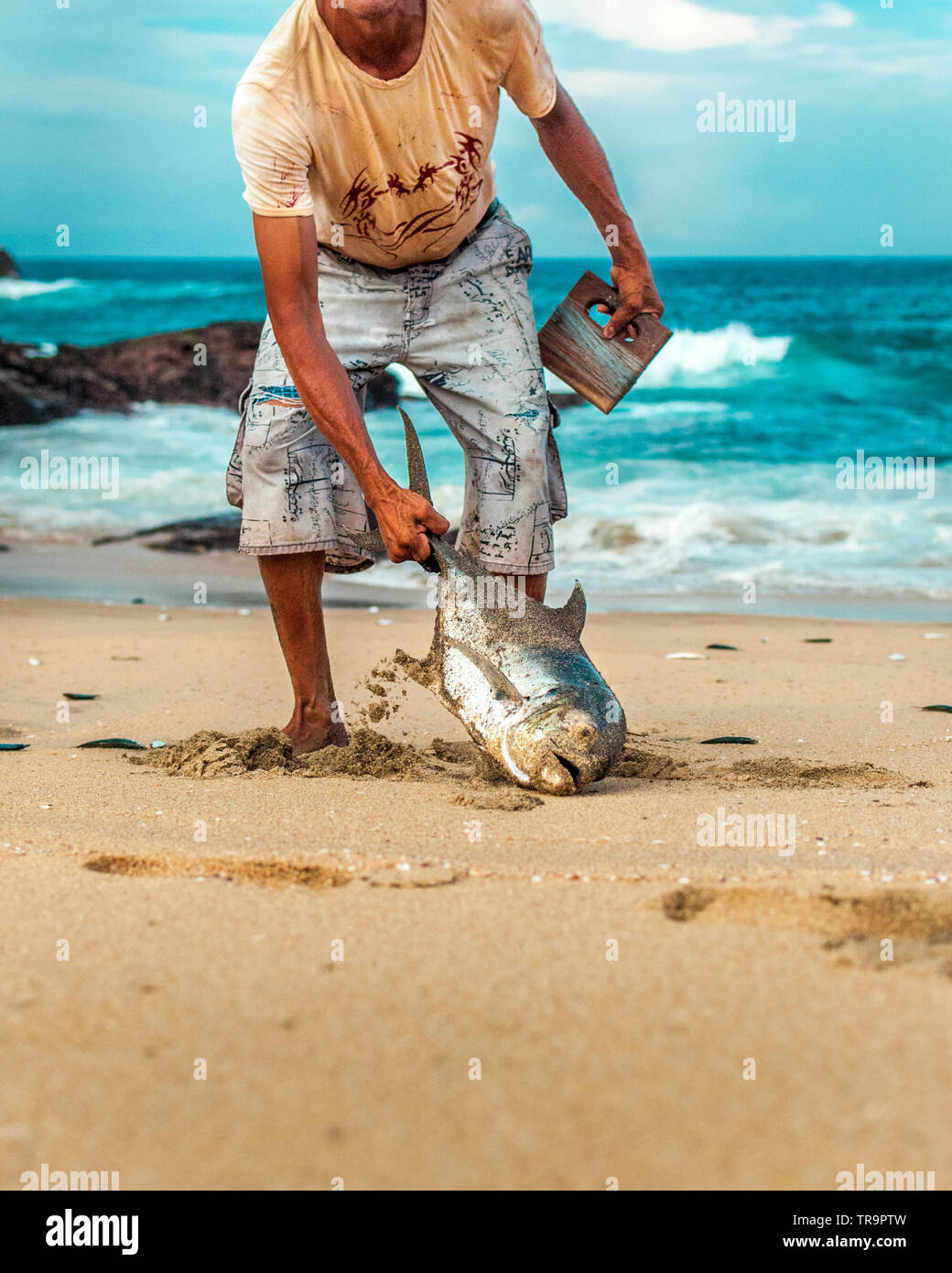 Fisherman carrying their catch of the day after fishing from the beach,  small scale fishing with fishing line, hooks and bare hands Stock Photo -  Alamy