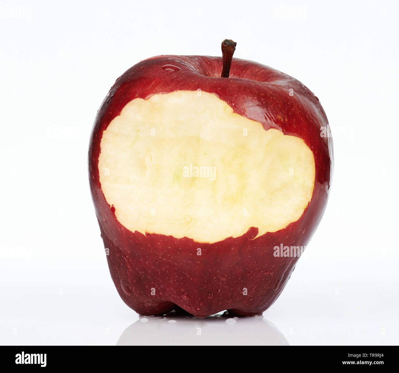 Close up of red apple with bite isolated on white background Stock
