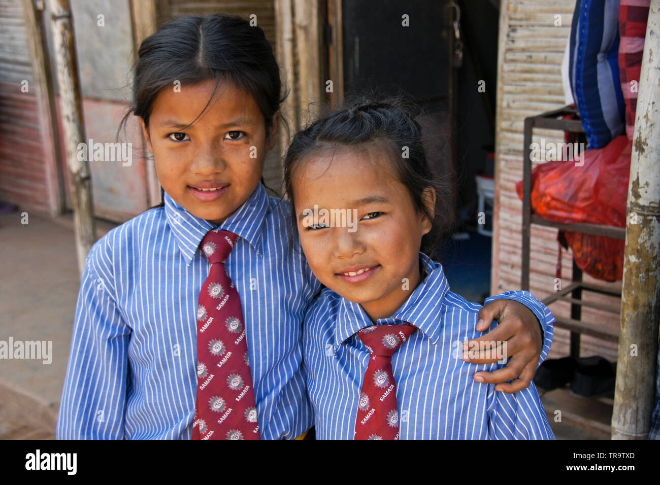 Two young girls in school uniform at Samata Bamboo School, Bhaktapur, Kathmandu Valley, Nepal Stock Photo