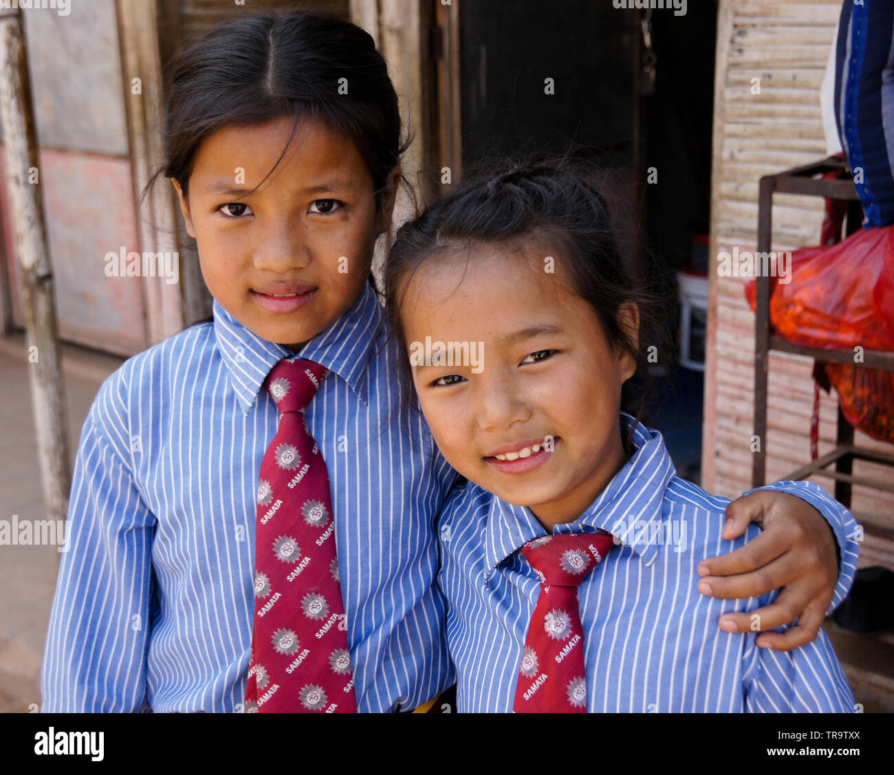 Two young girls in school uniform at Samata Bamboo School, Bhaktapur, Kathmandu Valley, Nepal Stock Photo
