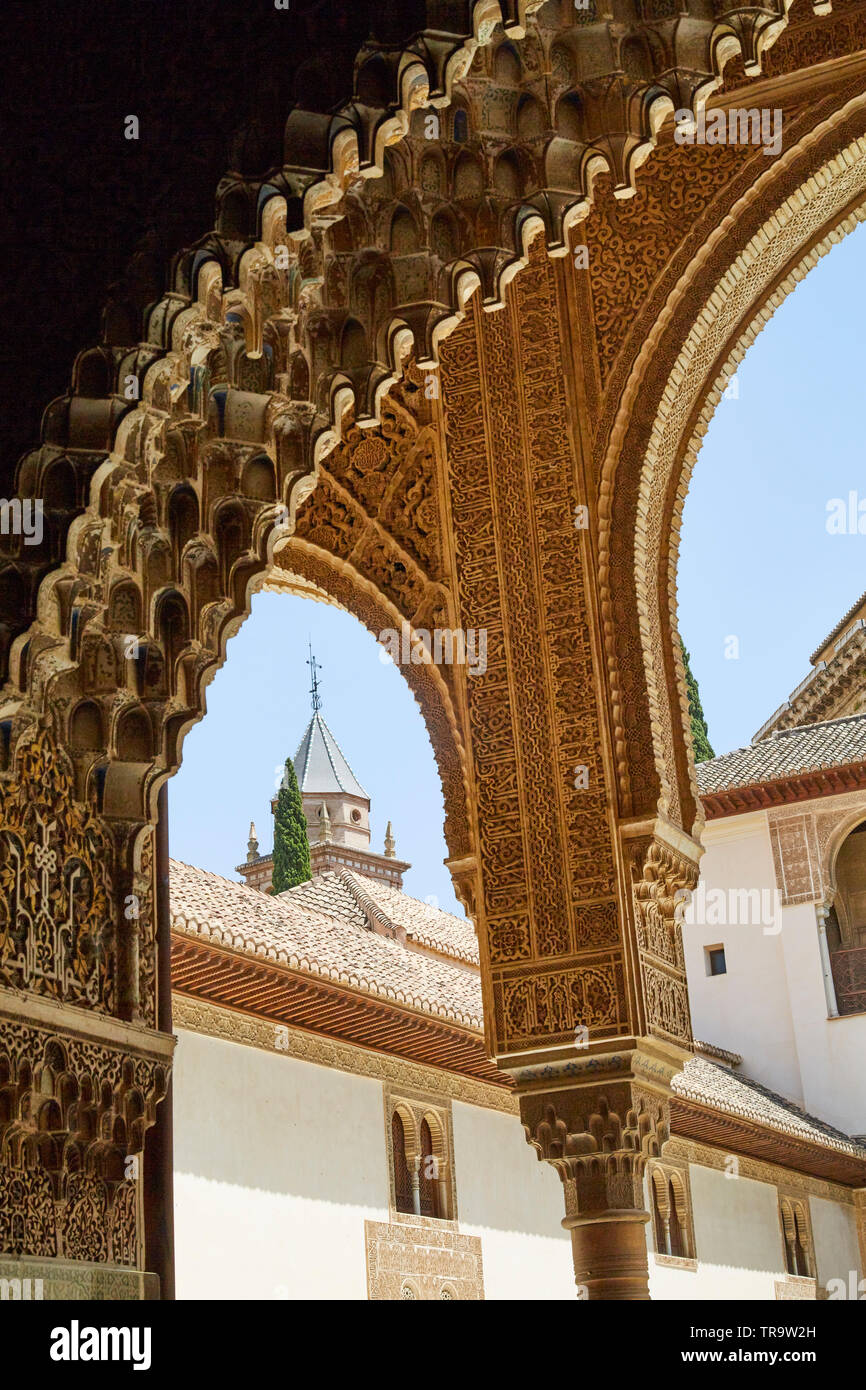 Tower viewed through intricate carved archways at Alhambra palace, in Granada, Spain. Stock Photo