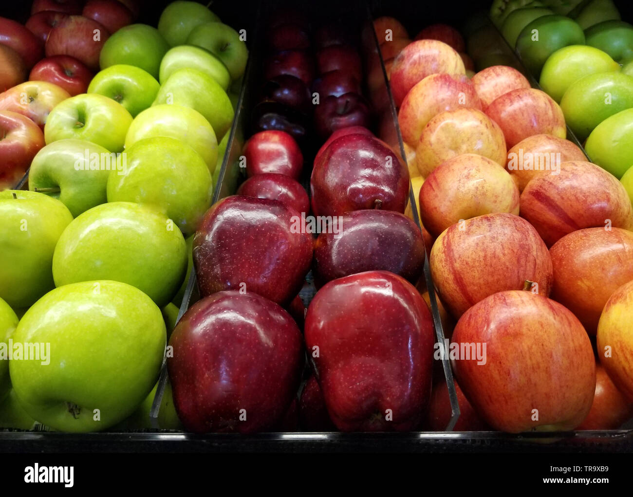 Fresh fruit grocery theme. Red and green apples in supermarket Stock