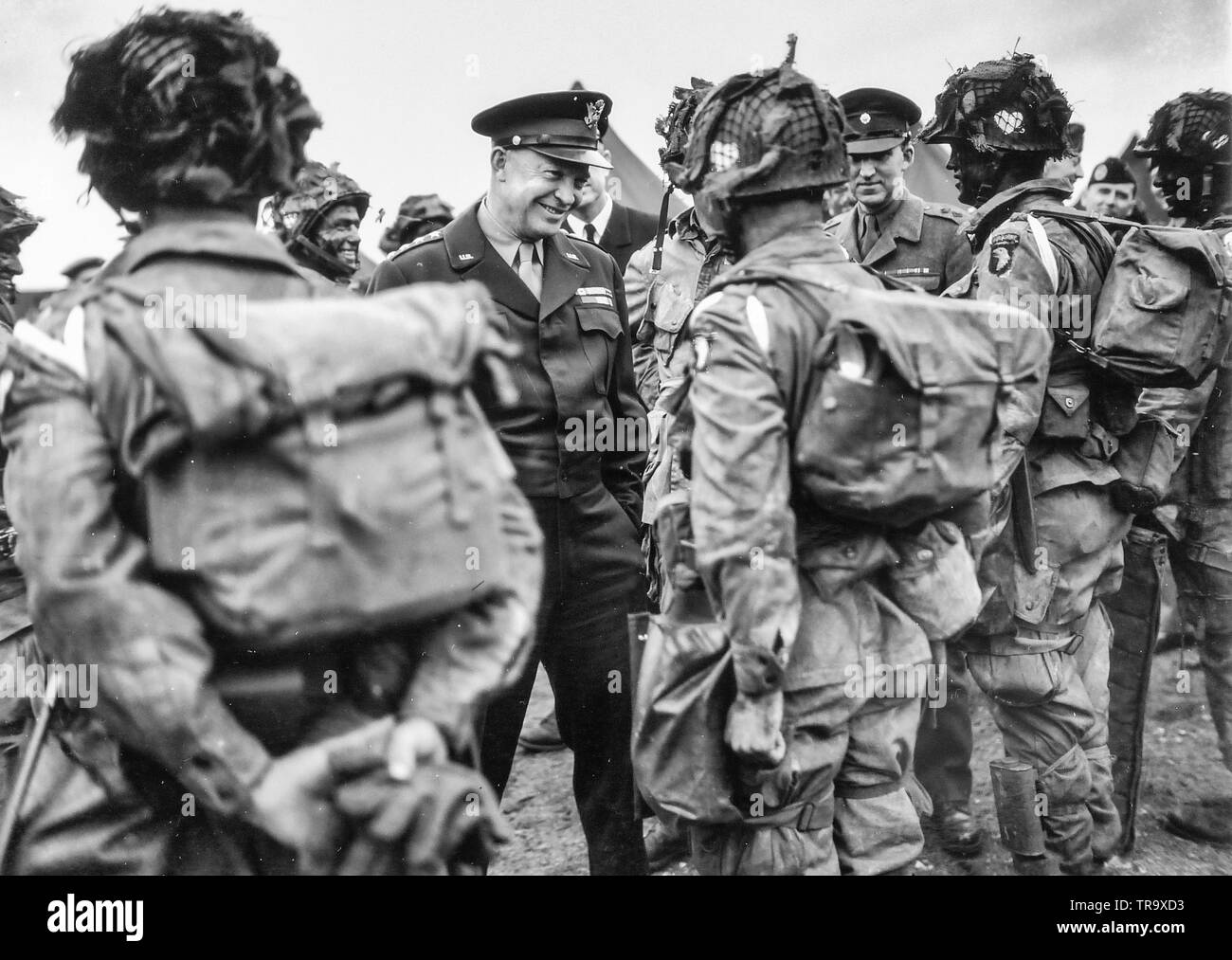 General Dwight D. Eisenhower gives the order of the day, 'Full victory, nothing less' to paratroopers somewhere in England just before they board their planes to take part in the first assault of the invasion of France. England. June 6, 1944. Stock Photo