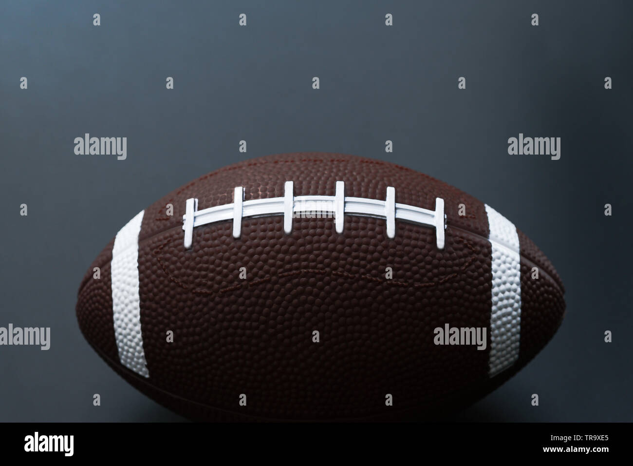American football isolated on black background . Sport object concept