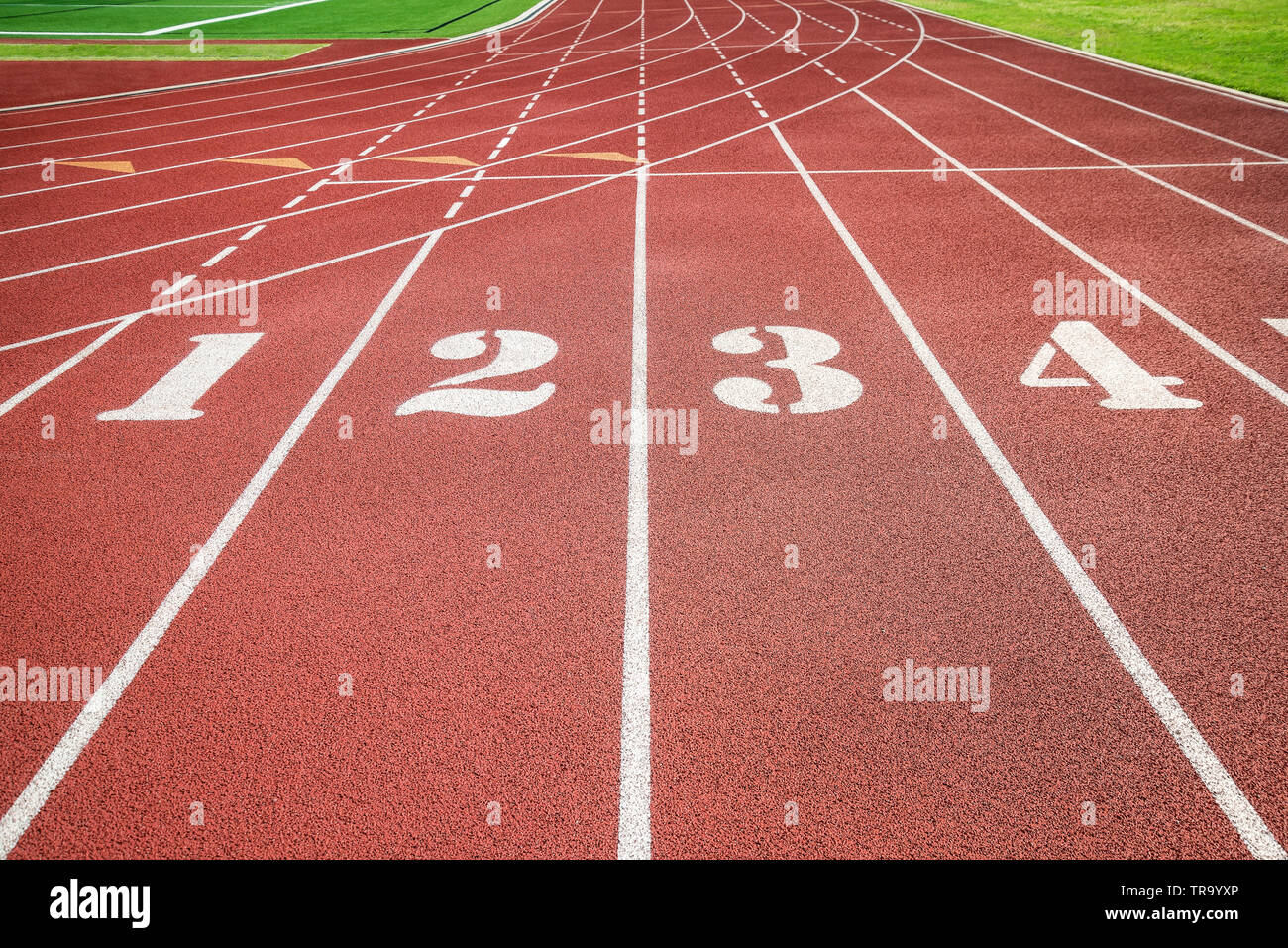 Red running track, track and field or athletics track start line with