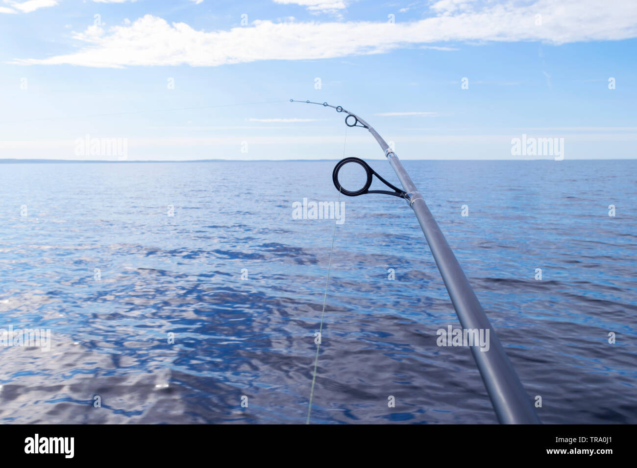 Fishing rod spinning ring with the line close-up. Fishing rod over the  crystal still water. Fishing rod rings. Fishing tackle. Fishing spinning  reel Stock Photo - Alamy