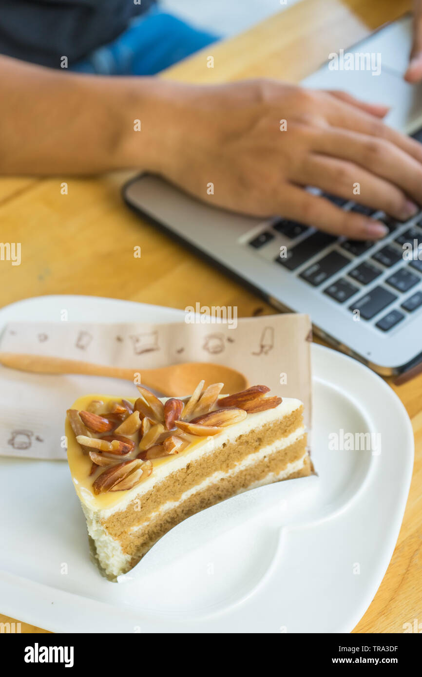 Bakery almond in plate on blurred notebook background, Stock Photo