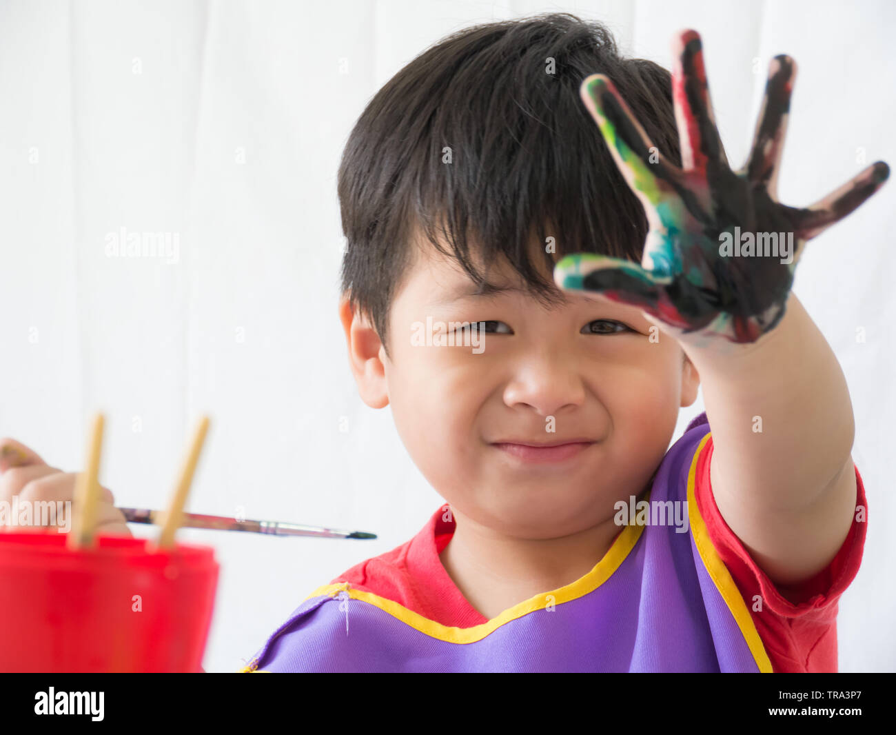 Little boy has a happy smile in coloring with blurred finger dirty, Stock Photo