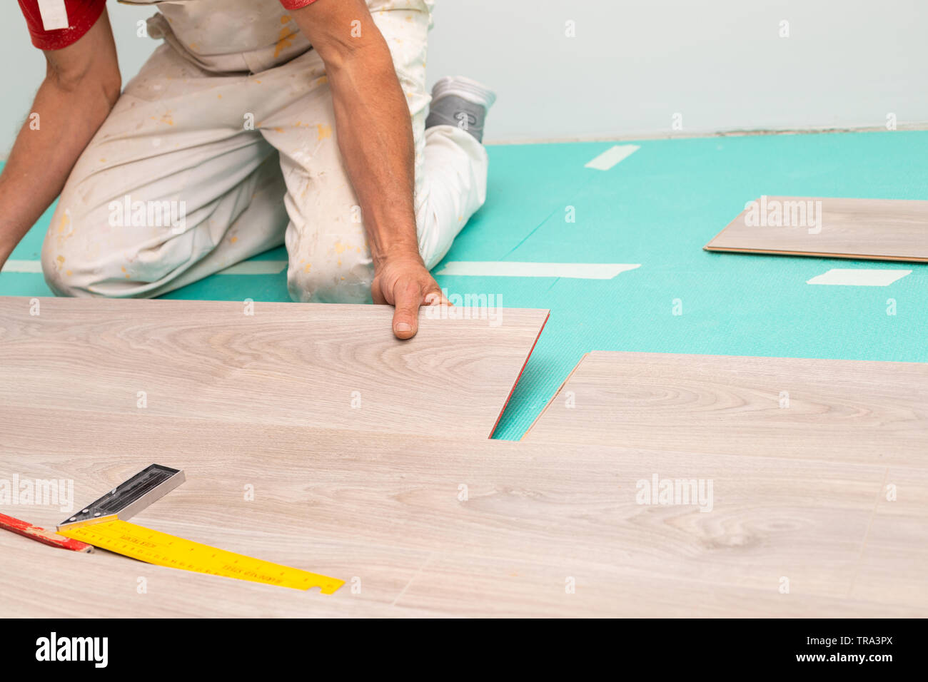 Curated visual reference: Visual Reference: Craftsman Installing Laminate Flooring In New Apartment Stock Photo
