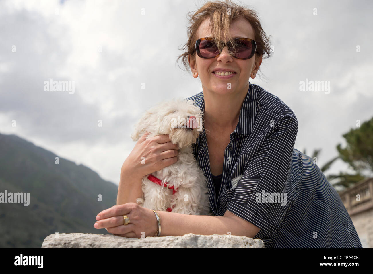 Dobrota, Montenegro, April 27th 2019: Woman posing with her doggy Stock Photo