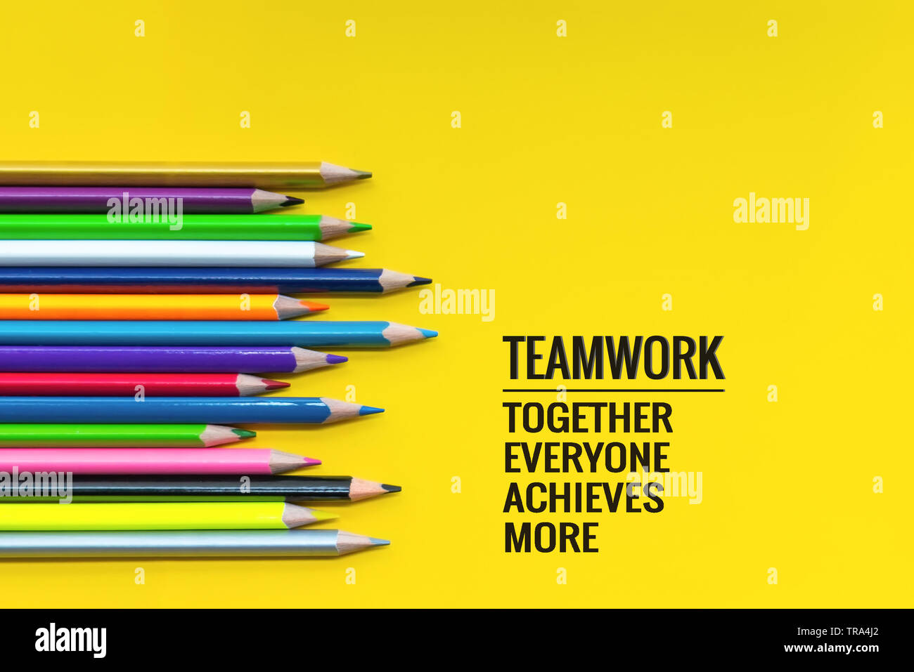Teamwork concept. group of color pencil on yellow background with word ...