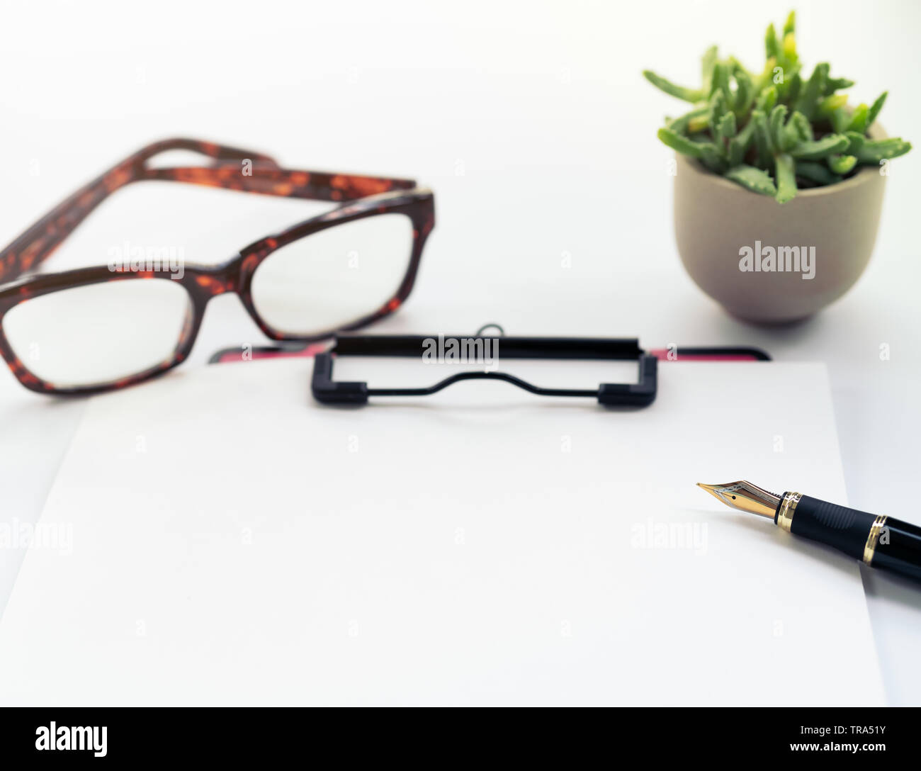 Business objects, clipboard with blank sheet of paper, pen, glasses on white background Stock Photo
