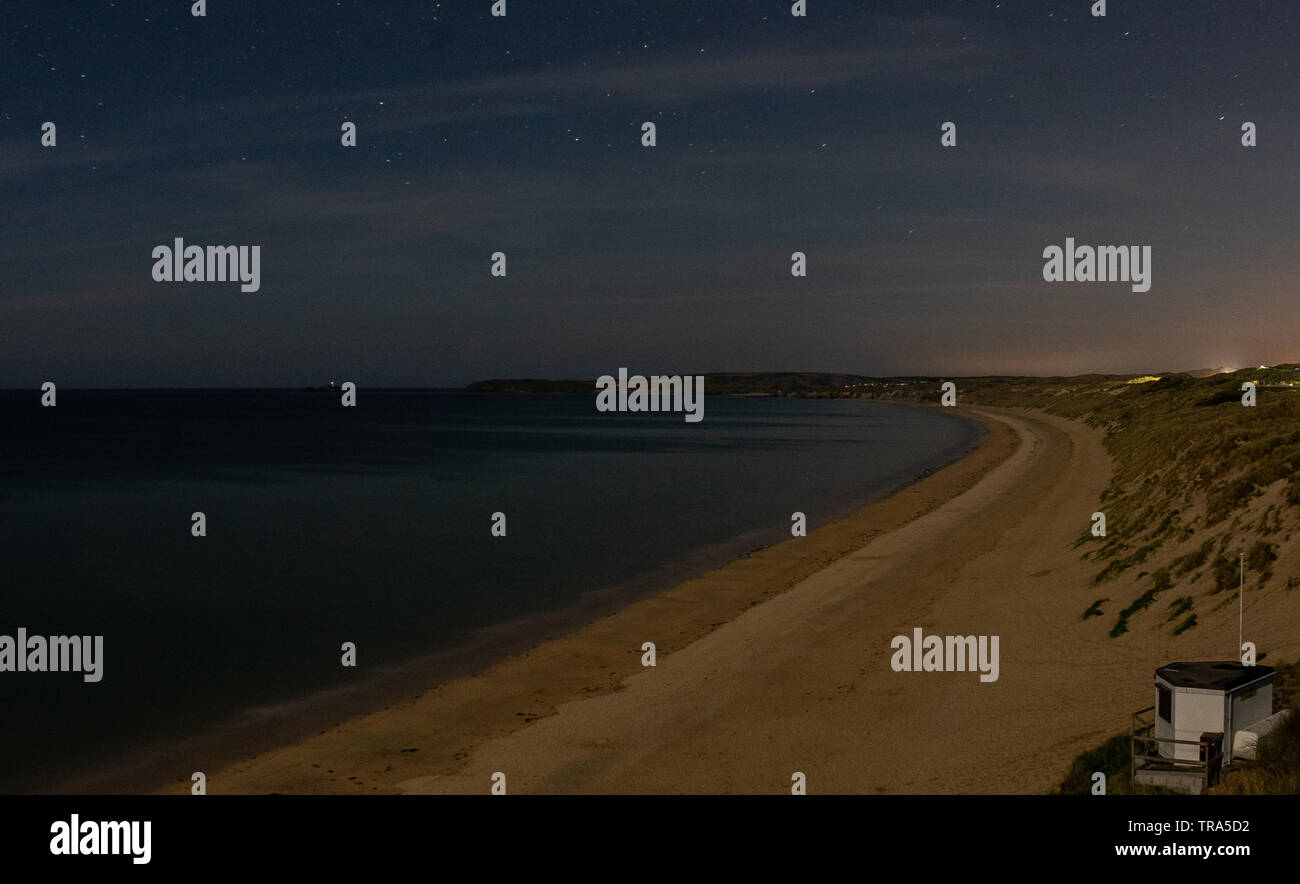 night time drone shot of Cornish Beach long exposure with stars Stock Photo