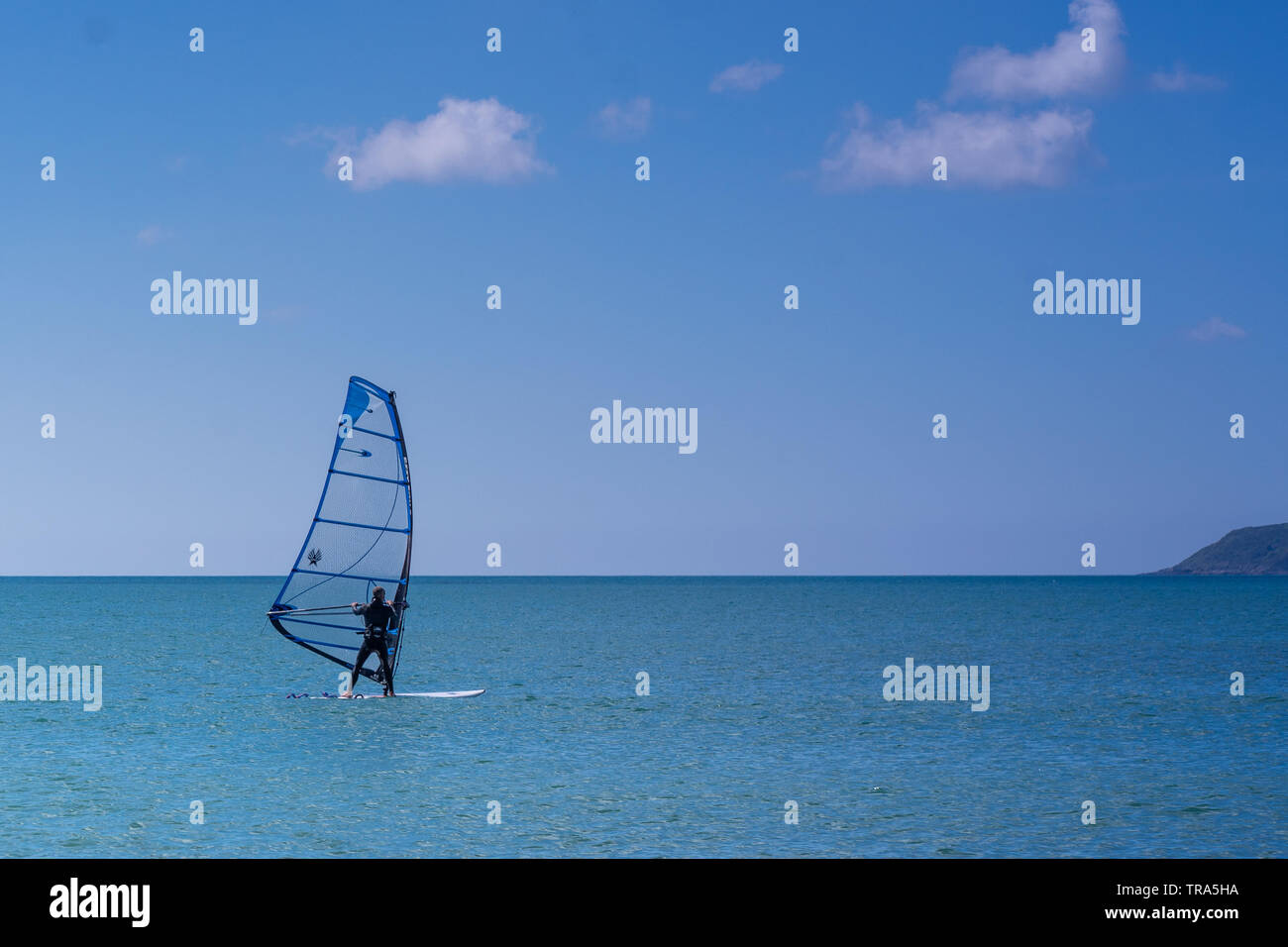 Male Windsurfing in Cornwall on a sunny day Stock Photo