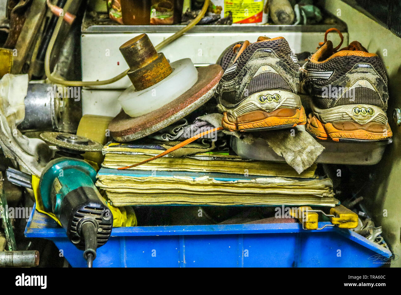 Different dumped and old stuff like shoes papers and wheel. Stock Photo