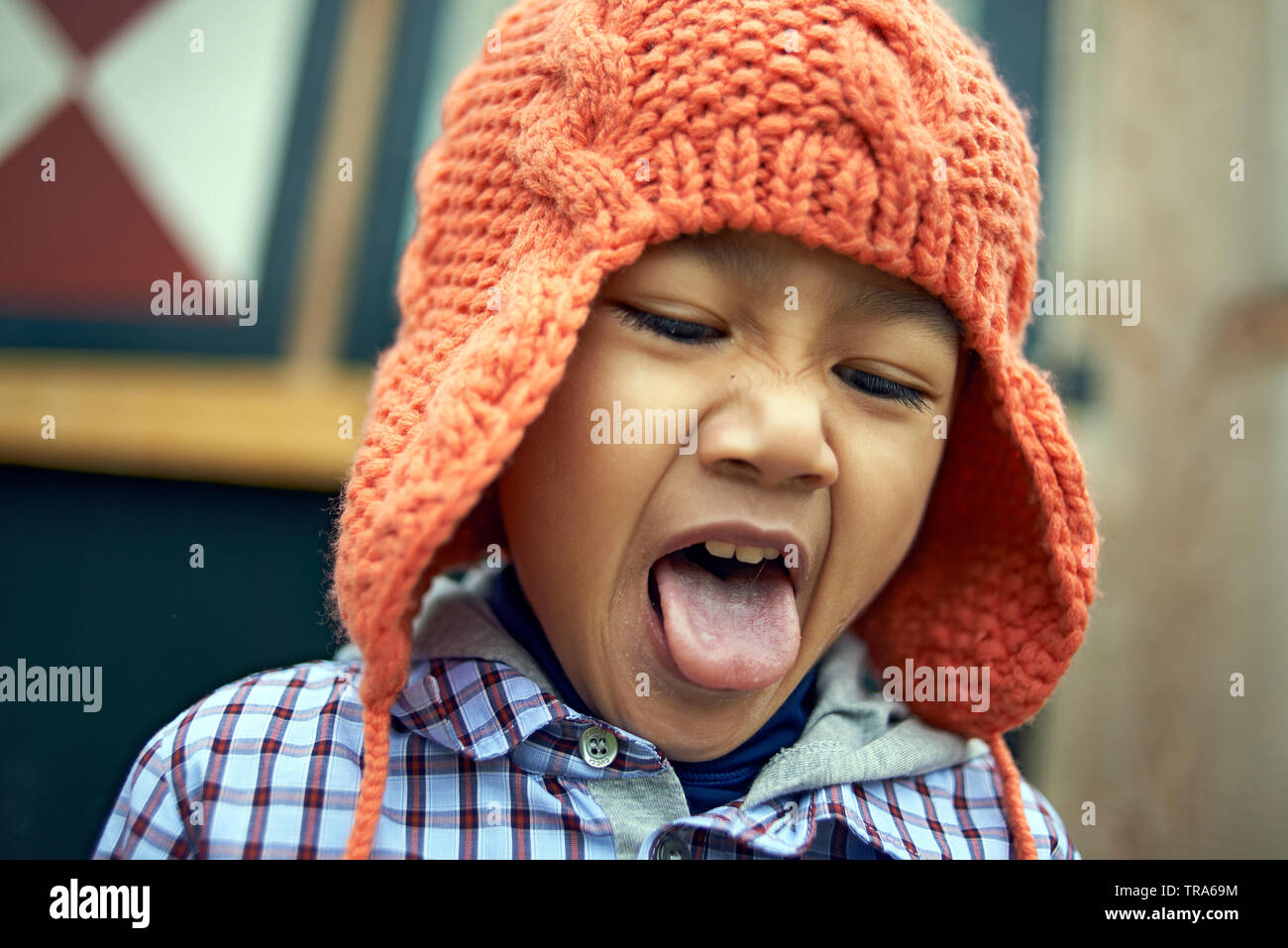 Portrait of an adorable little Asian boy with big brown eyes in a park