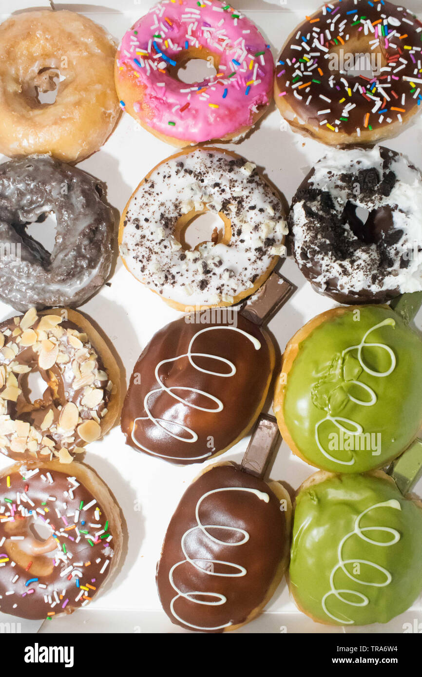 Assorted flavored doughnuts on a white background Stock Photo - Alamy