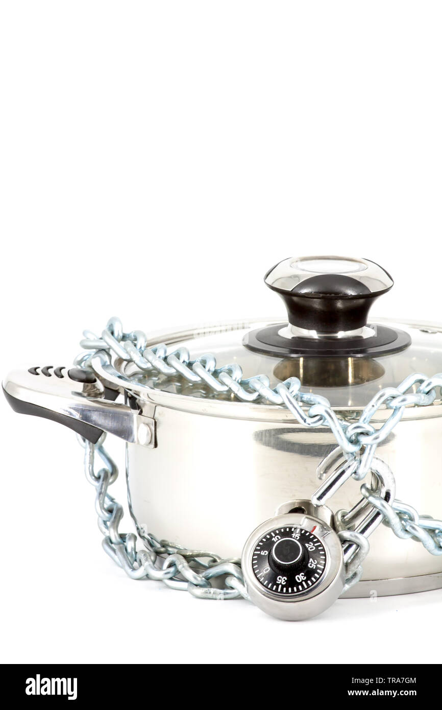 Chain with a padlock around a metal saucepan on a white background Stock Photo