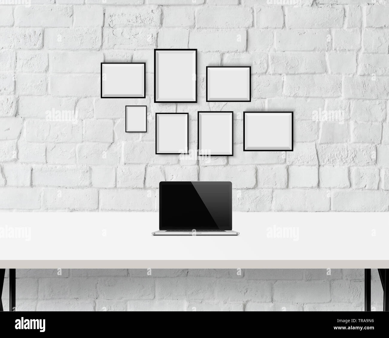 Minimal interior, empty frames, wall art, work space, mac book on table Stock Photo