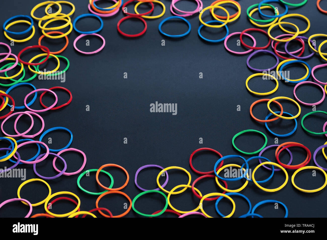 Information sharing concept, colorful rubber band on black background with copy space Stock Photo