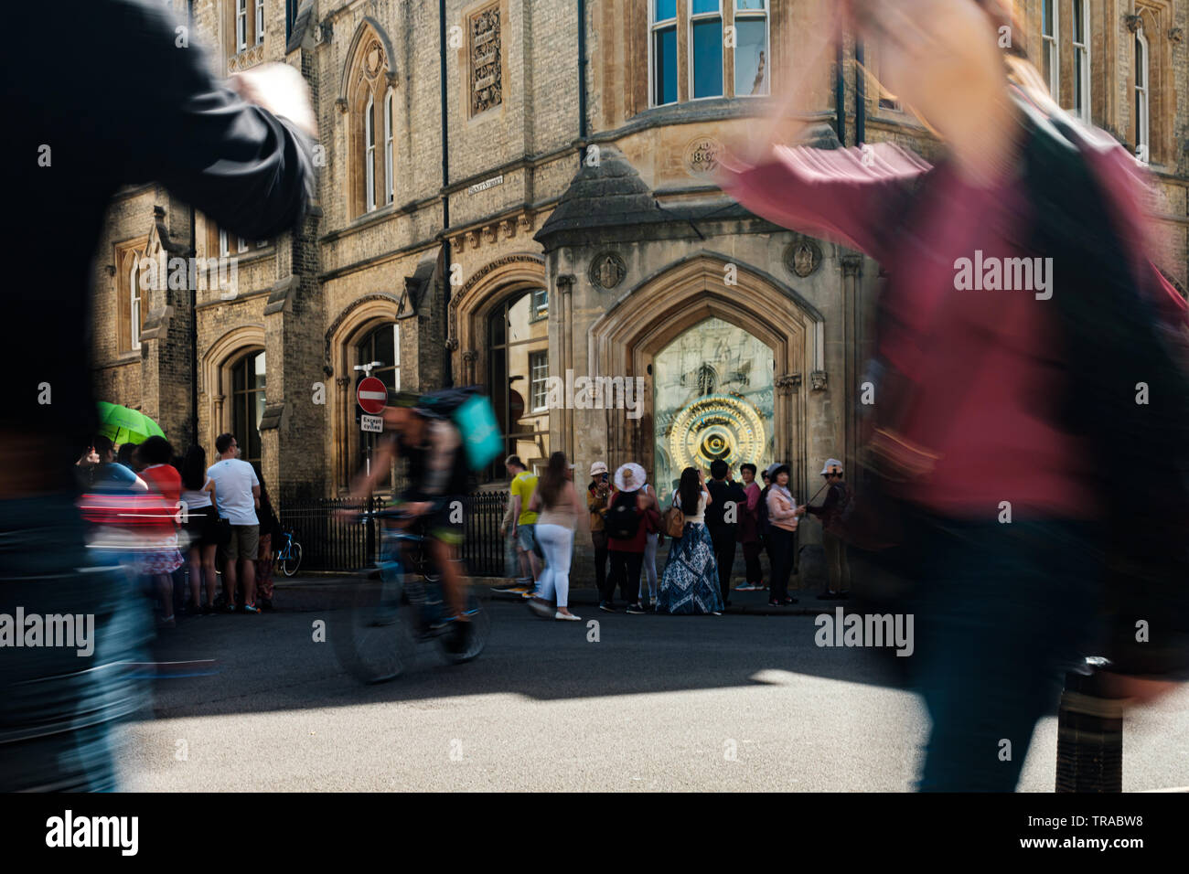 Tourists in Cambridge photograph and walk past the The Taylor Library ...