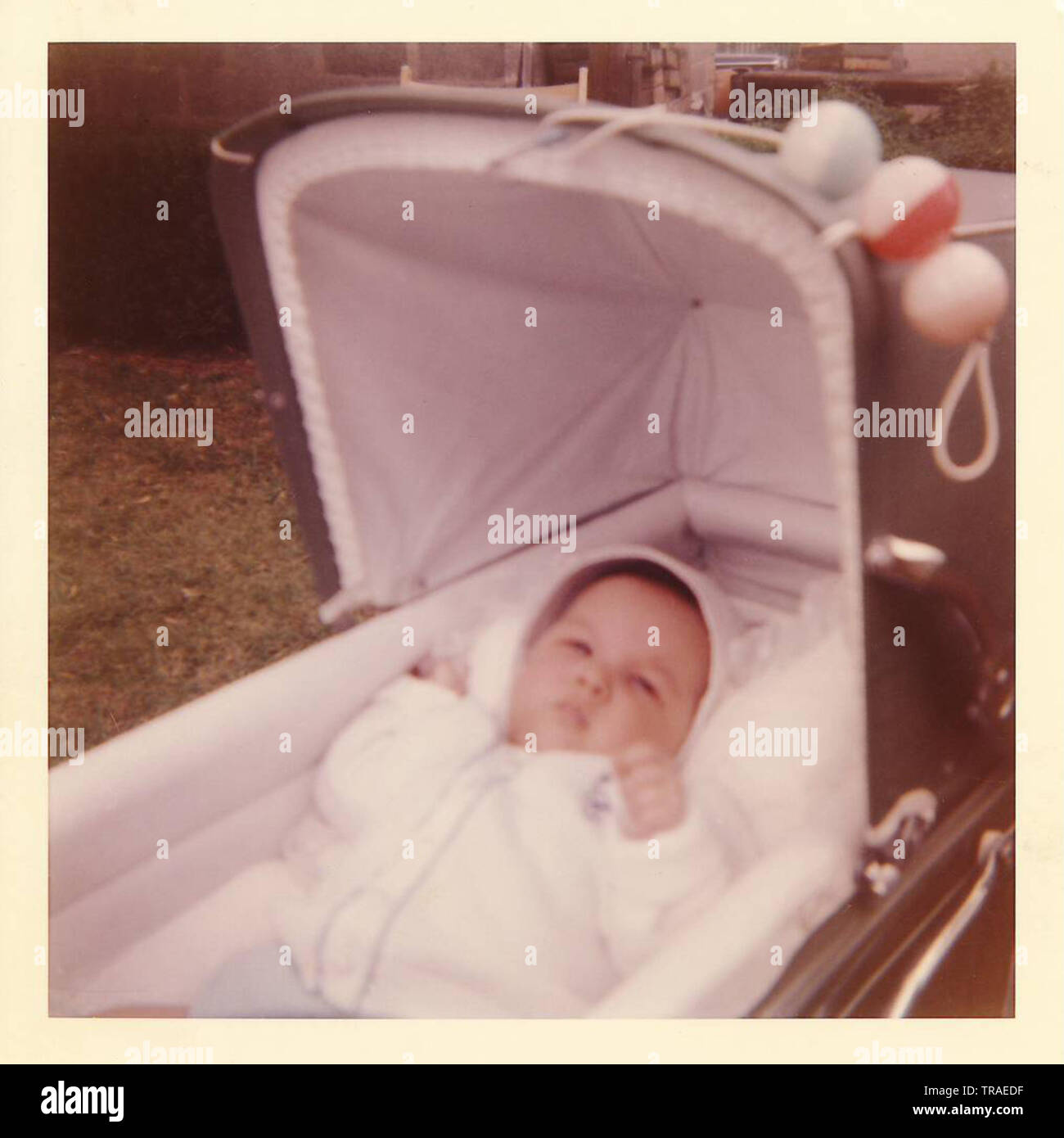 A vintage photo of a three month old baby boy in 1965, in a baby carriage. Stock Photo