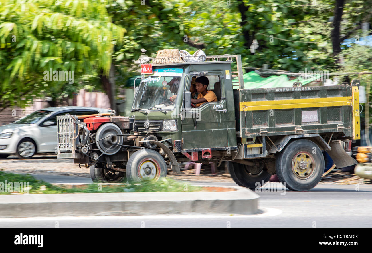 MANDALAY, MYANMAR, MAY 20 2018, Chinese Manufactured tractor truck ride on street at Mandalay city. Typical open-fronted battered lorry vehicle with a Stock Photo