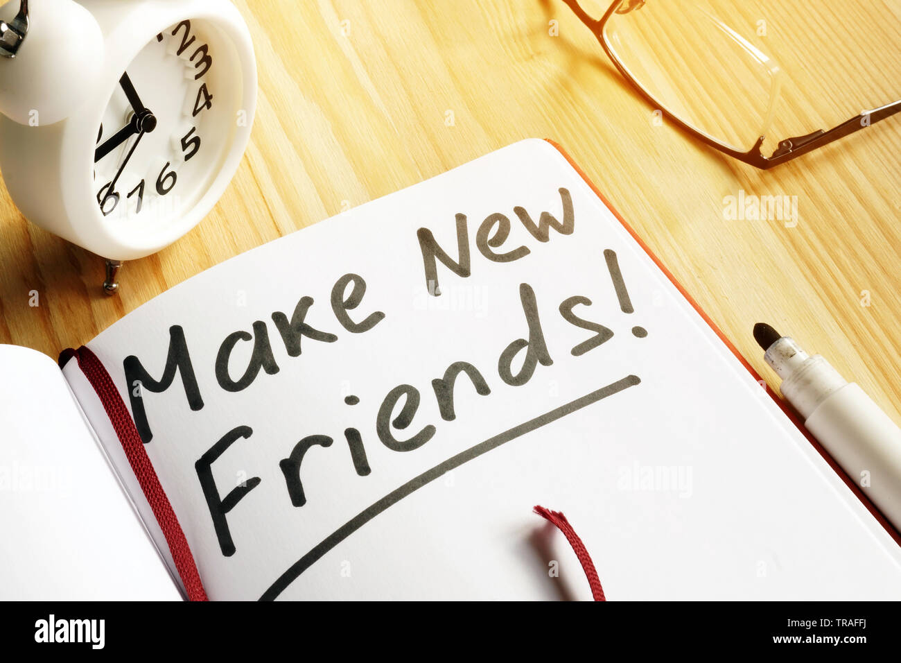 Make new friends. Networking concept. Note pad and alarm clock. Stock Photo