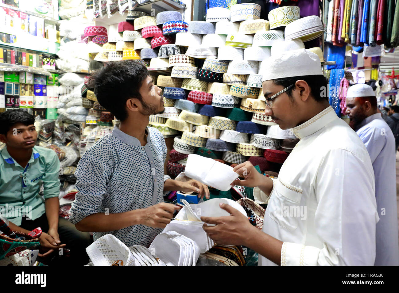 A customer trying a tupi or prayer cap 