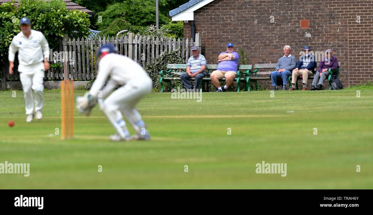 Five elderly men watch the match in the Derbyshire and Cheshire League