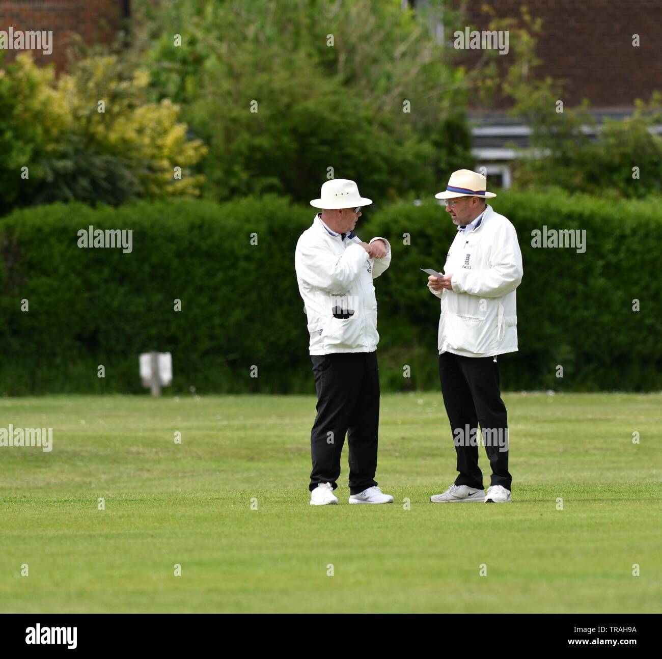 The umpires confer in the Derbyshire and Cheshire League match between