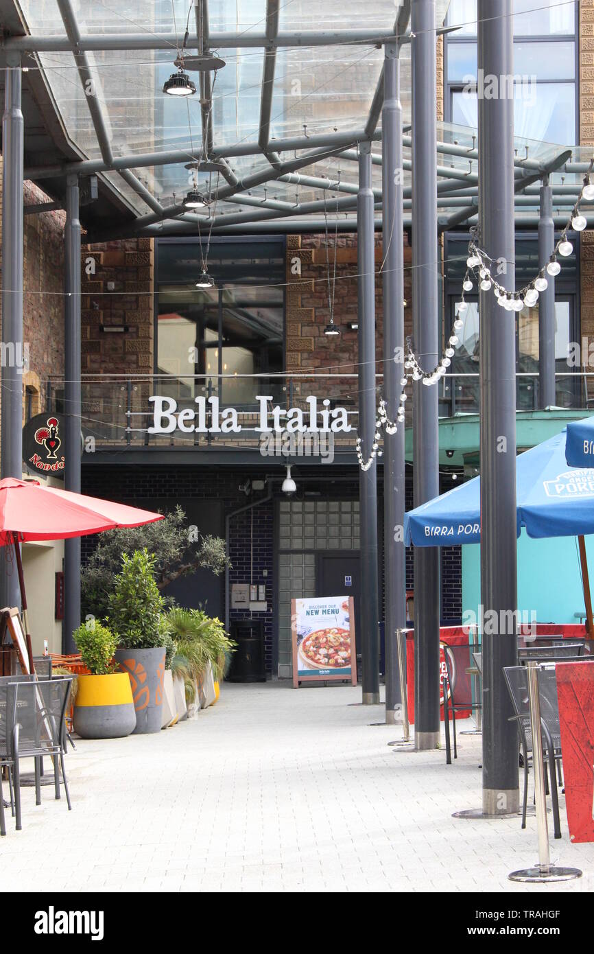A photograph of restaurants in Cardiff, Wales, UK, May 2019.  Exterior of Bella Italia and Nandos in an al fresco setting Stock Photo