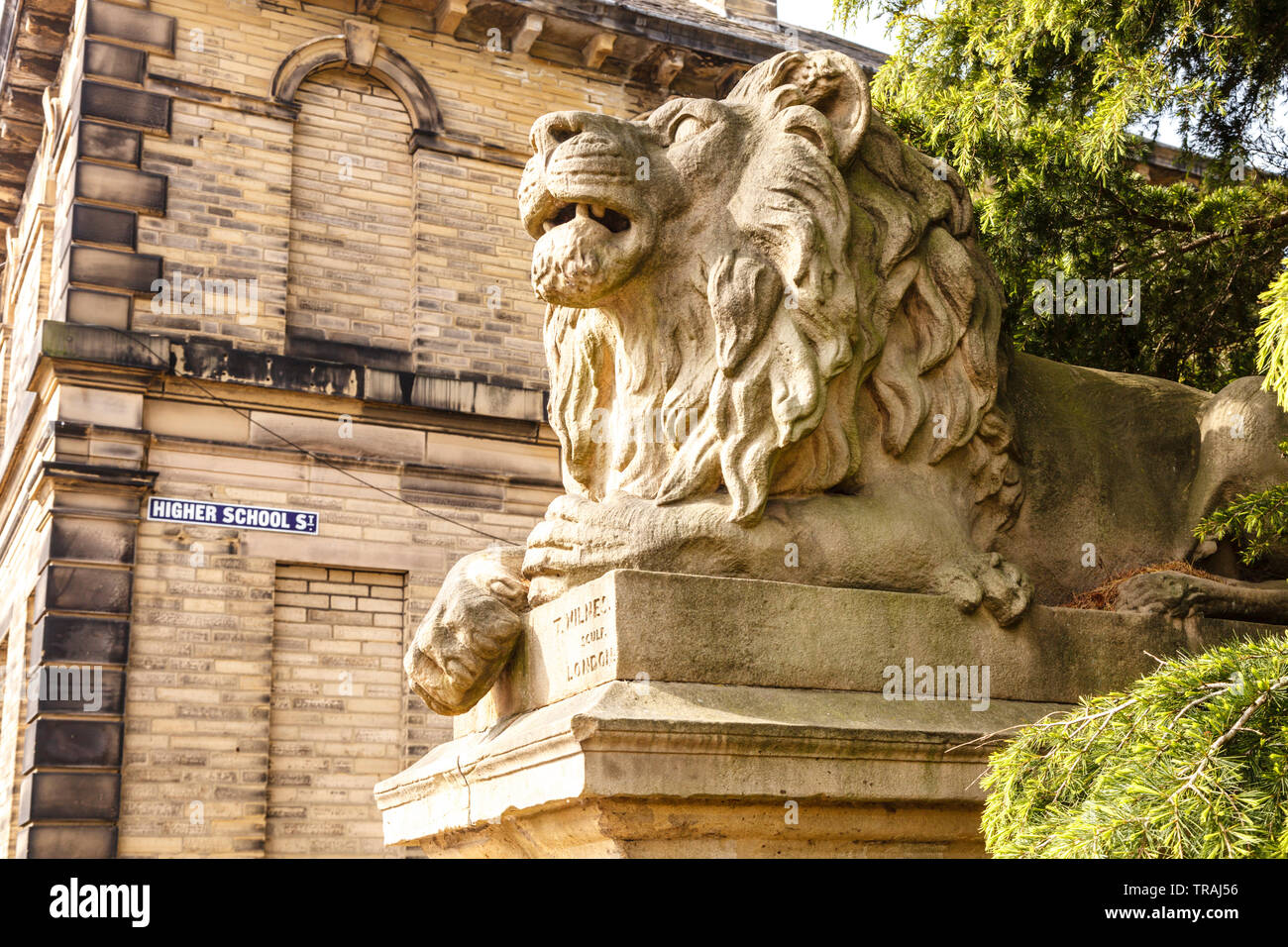 Determination, one of the two lion sculpture outside the Factory School in Saltaire, Bradford, West Yorkshire Stock Photo