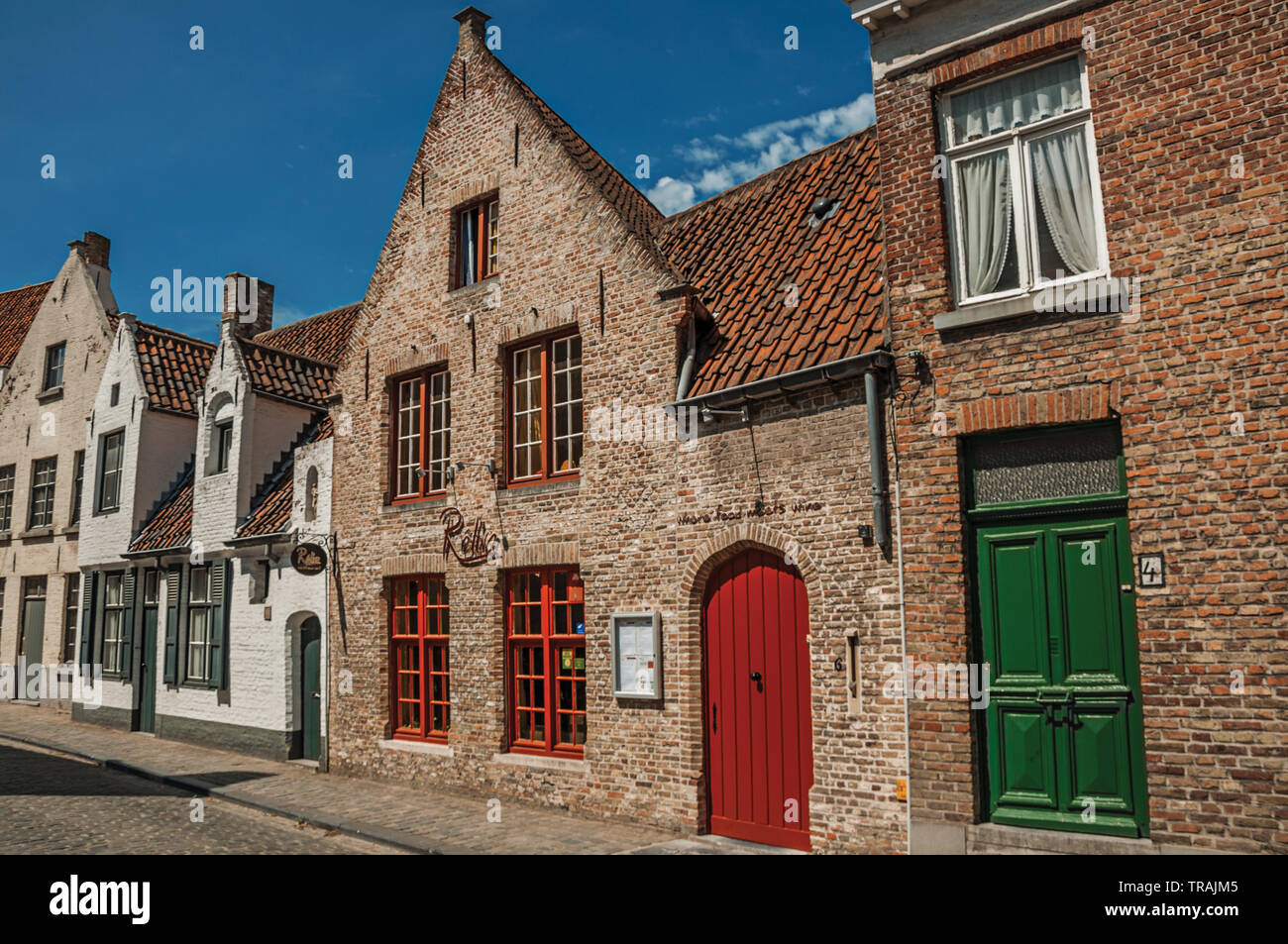 Brick facade of old houses in street of Bruges. Charming town with canals and old buildings in Belgium. Stock Photo