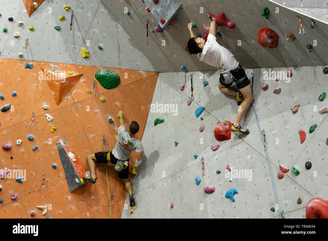 Manila, Philippines - 1, June, 2019: A man climbing up the wall in rock climbing center in Ortigas Stock Photo