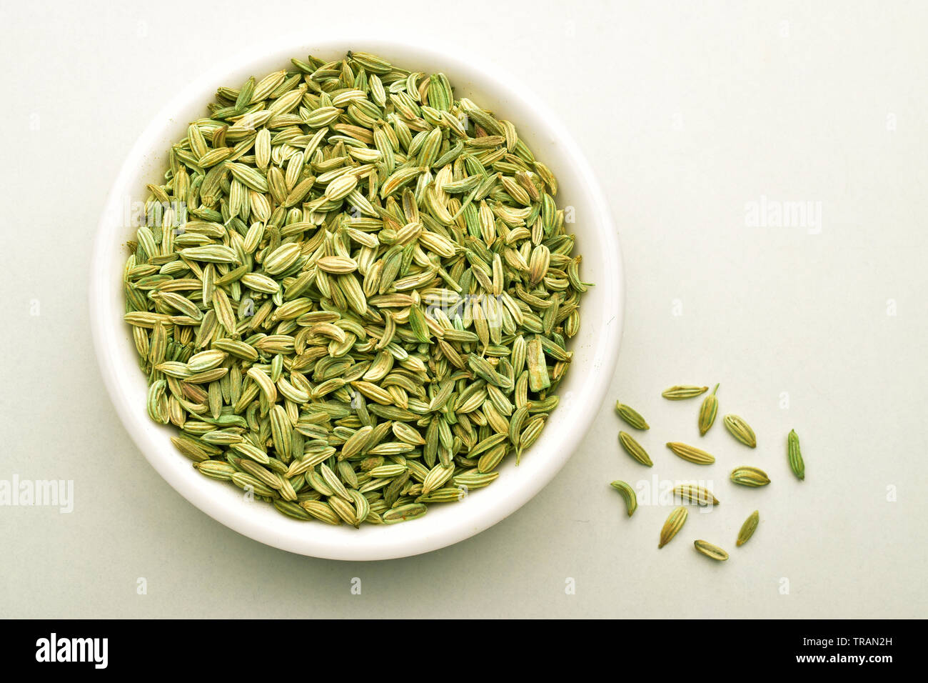 fennel seeds in white bowl isolated on white background, top view Stock Photo