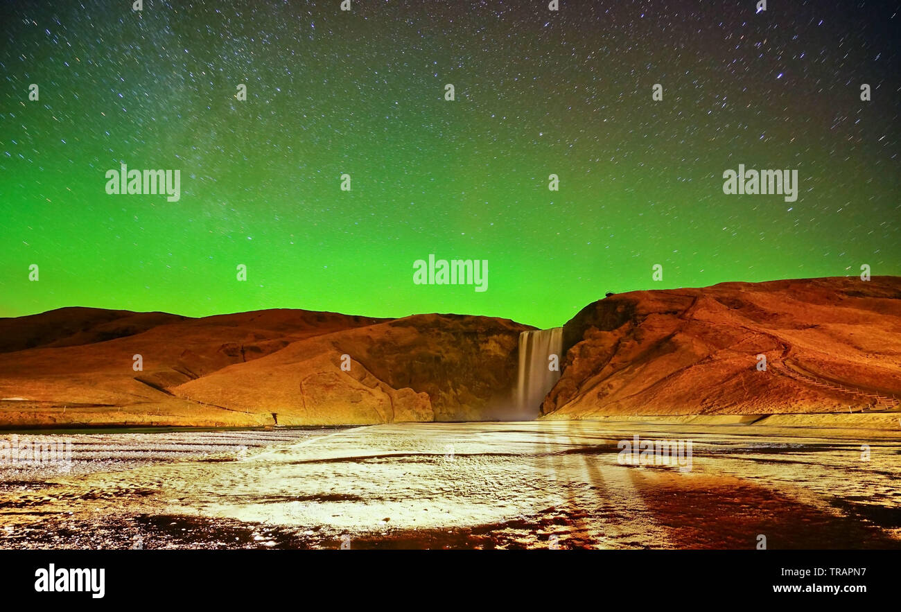 View of the northern light at Skogafoss waterfall in Iceland. Stock Photo