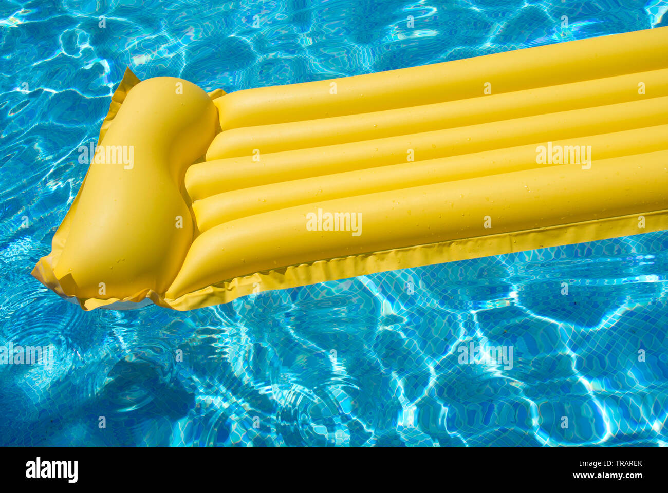 Yellow inflatable mat bed blue water hi-res stock photography and ...