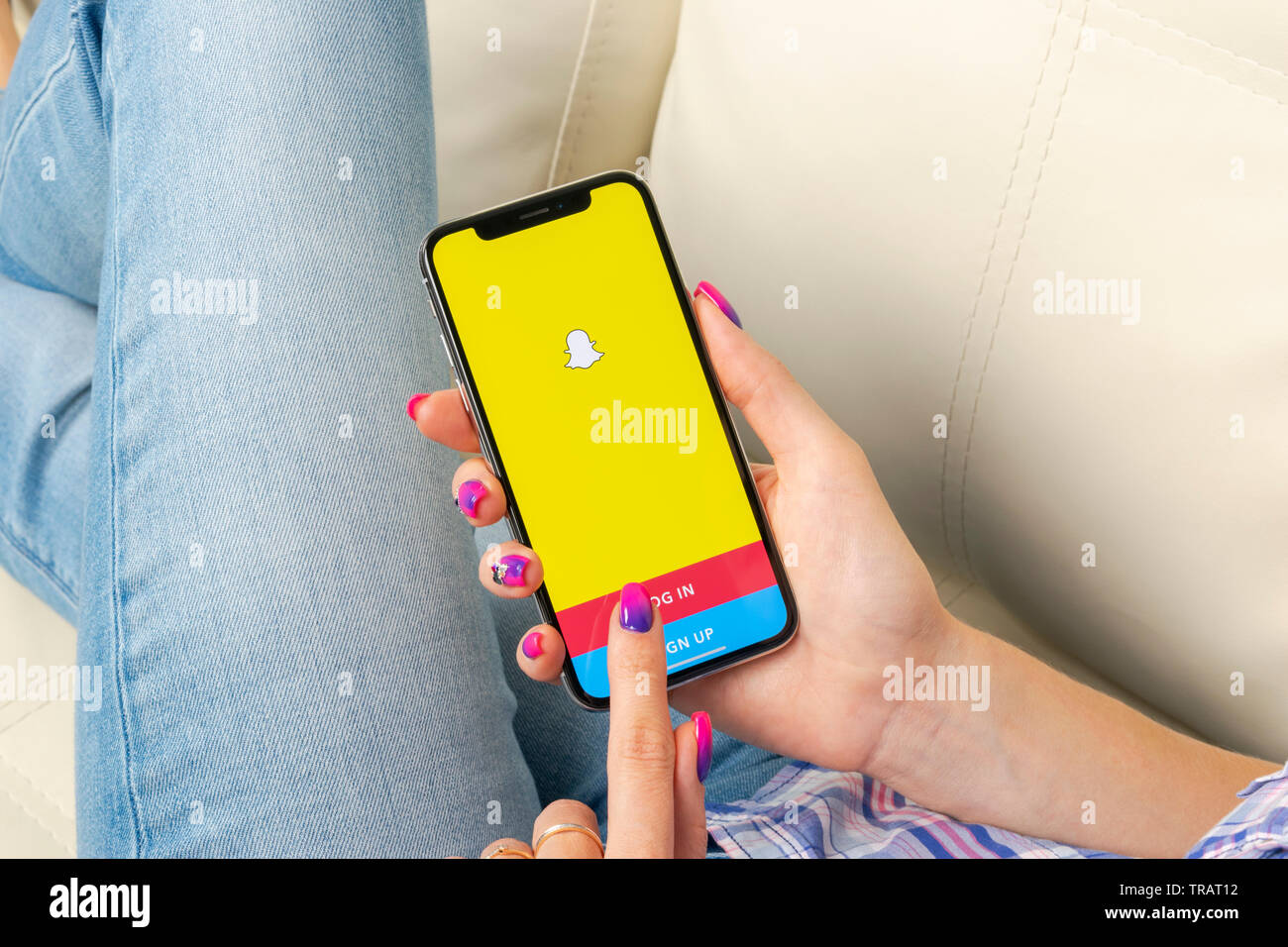 Sankt-Petersburg, Russia, May 30, 2018: Snapchat application icon on Apple iPhone X smartphone screen close-up in woman hands. Snapchat app icon. Soci Stock Photo