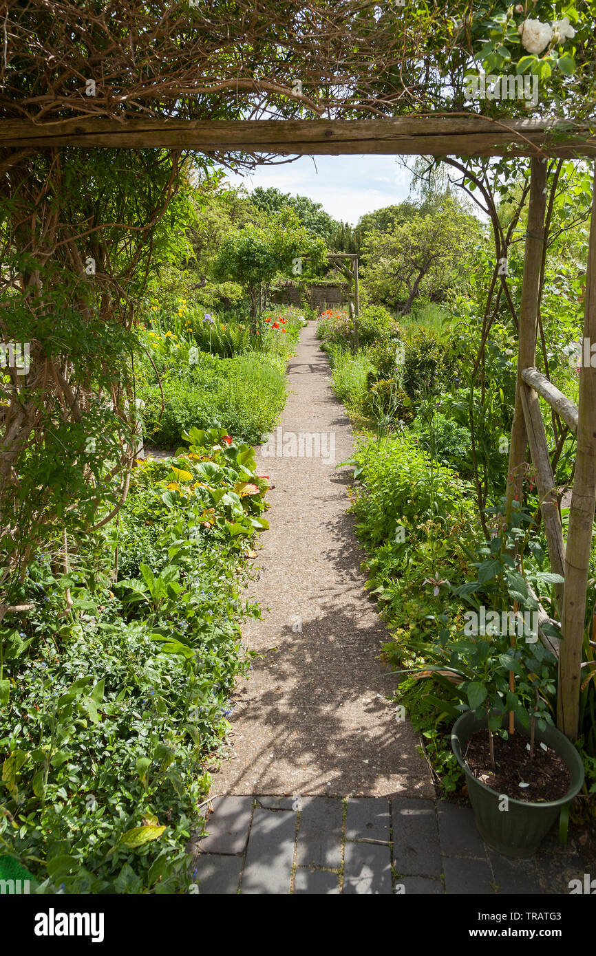 Garden path, view through a garden entrance Stock Photo