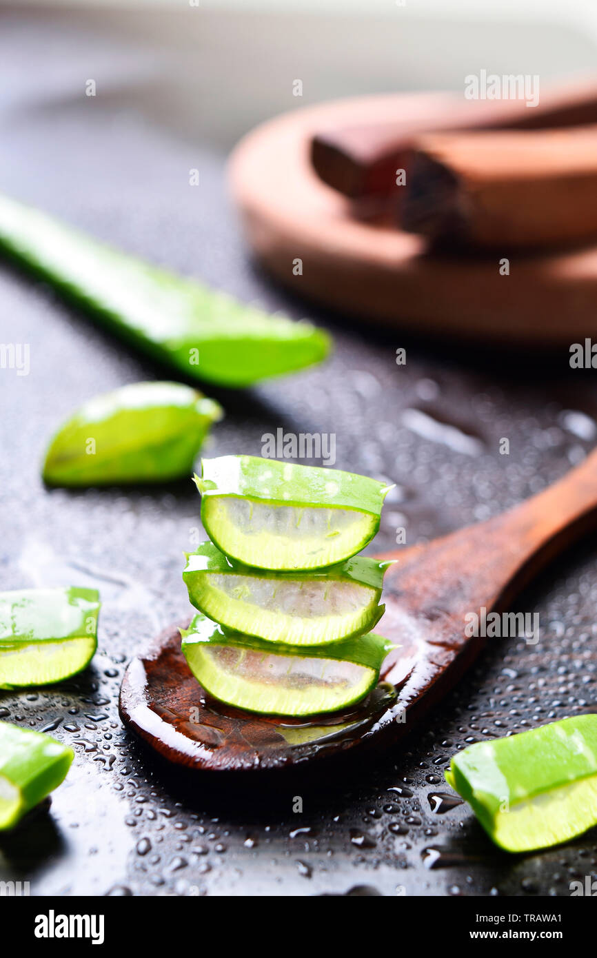 aloe vera slices with wooden spoon and sandal wood in background, water  drops, beautiful images, fresh concept, wallpaper Stock Photo - Alamy