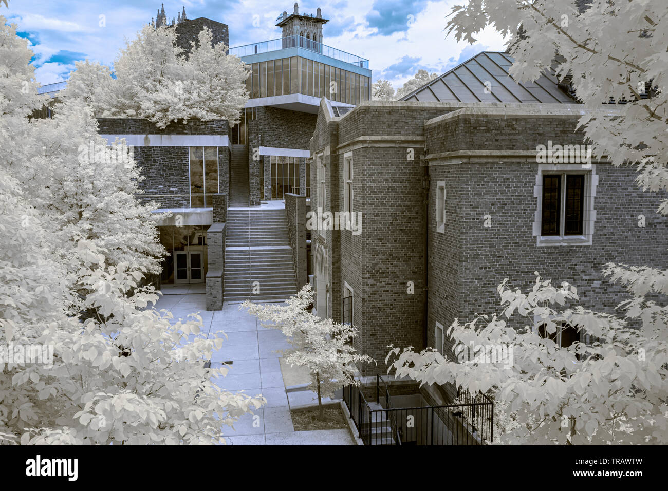 A courtyard amid stone buildings in a stark infrared photograph Stock Photo