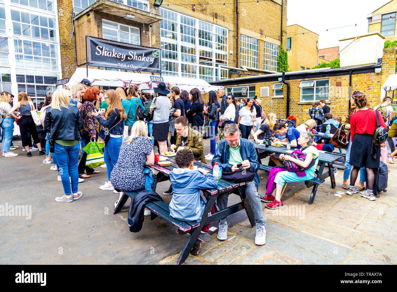 27th May 2019 People sitting in the backyard of the Boiler House eating at the Free From Festival, London, UK Stock Photo