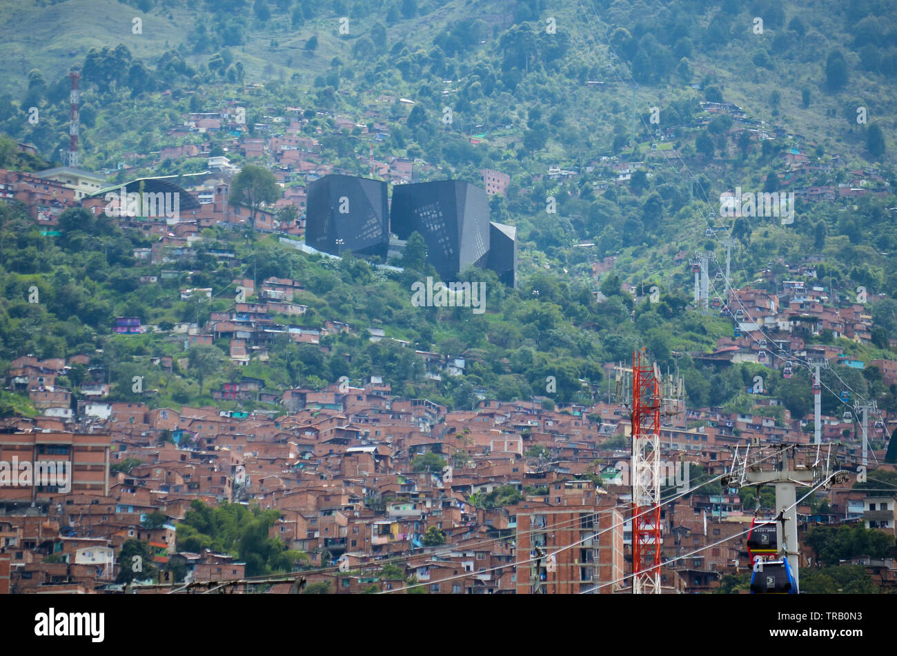 Santo Domingo Savio neighborhood in Medellin; the Spain Library Park is seen in the distance Stock Photo