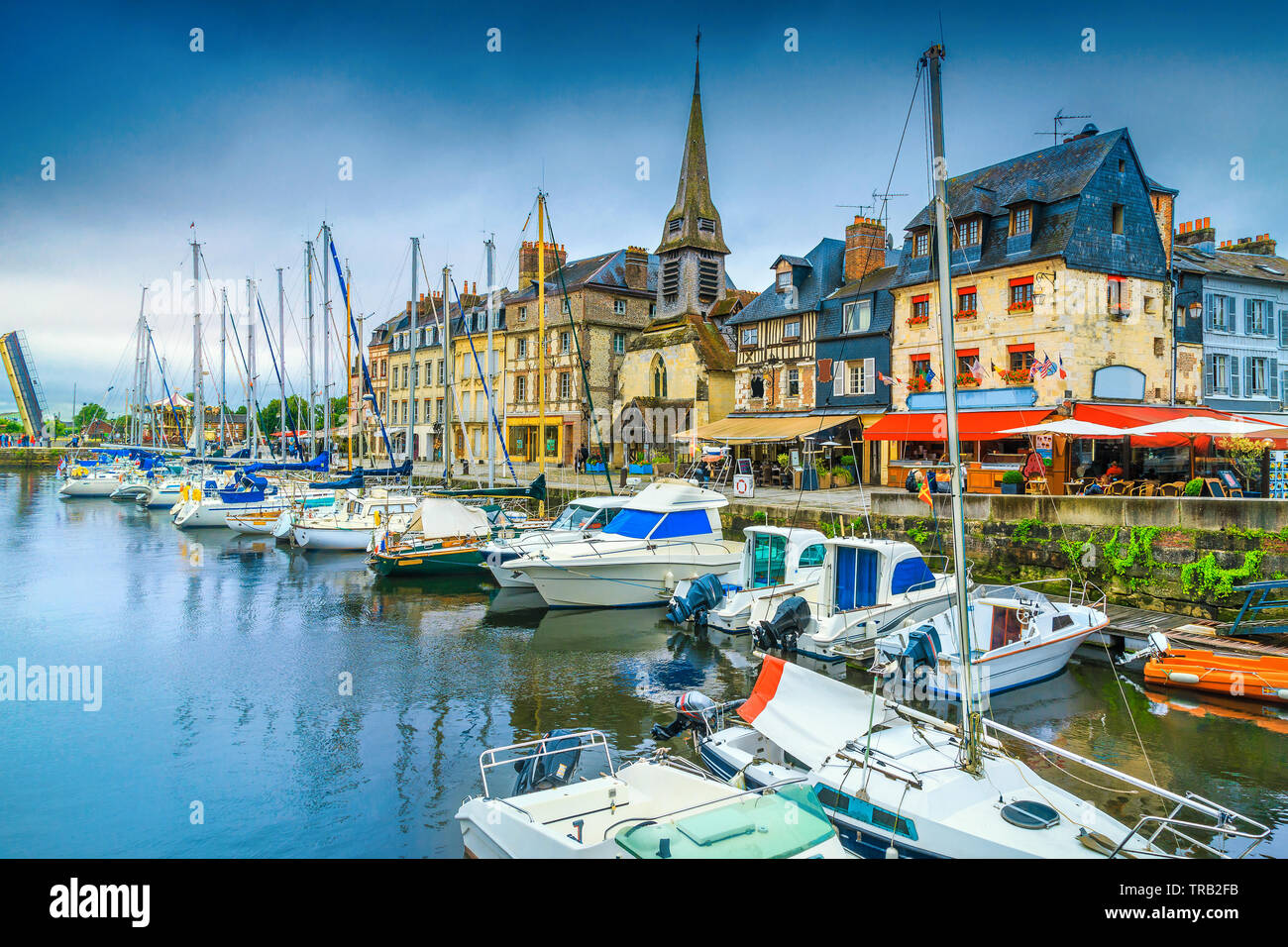Picturesque waterfront and promenade with street cafes. Amazing cityscape and harbor with boats in Honfleur. Popular travel and leisure destination, N Stock Photo